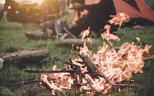 Couple travel camping in countryside with campfire, Great warm evening, camping concept.
