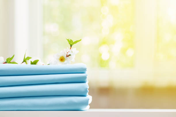 istock Closeup stack of blue clean bedding on the table. Blurred background. Copy space. 1151819044