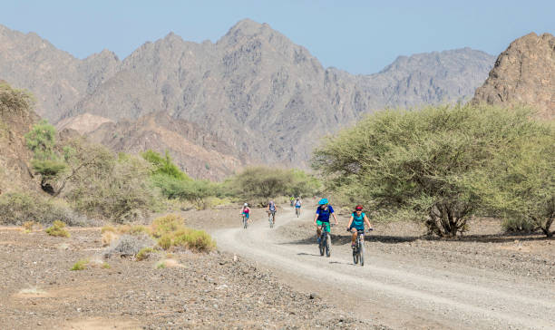 istock Small group of mountainbikers at Hajar Mountains Valley, Oman. 1151821230