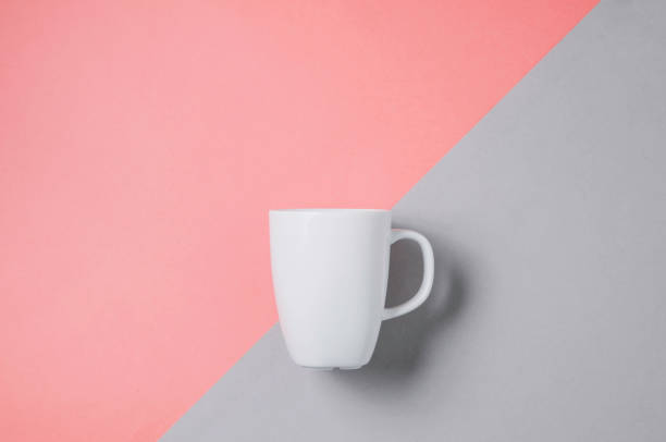 istock White mug on pale pink background. Template for text or design 1151822063