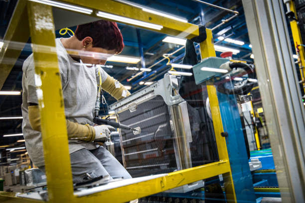 istock Woman constructing a metal frame for a washing machine 1151823330