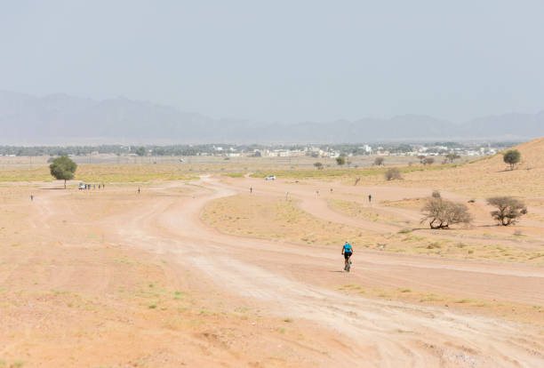 istock Mountainbiker is leaving Wahiba Sands, Oman. 1151823653