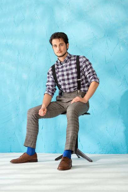istock Young man in shirt and vest against blue back 1151823882