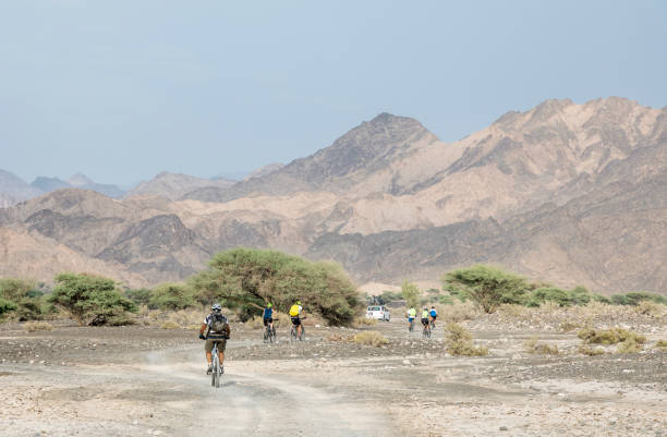 istock Group of mountainbikers at Hajar Mountains Valley, Oman. 1151826259
