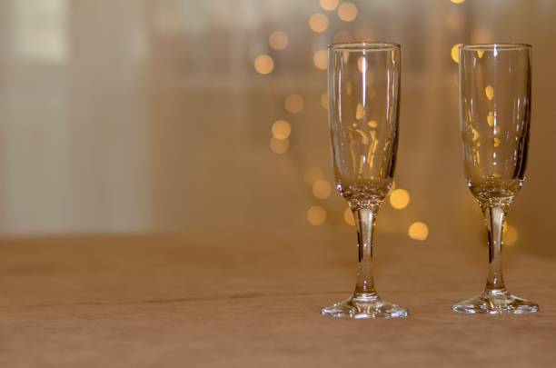 istock Two glasses in the light of lights. 1151826365
