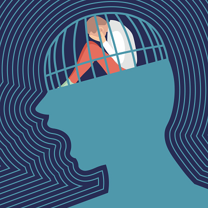 sad person is siting and crying in a screaming head prison. Concept of  depression. Flat vector illustration.