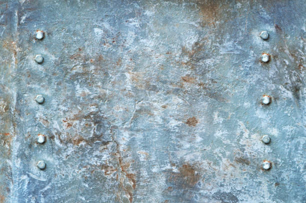 istock textured weathered metallic wall, retro vintage backdrop, empty template.Old rusty background. texture of the iron. Metal natural pattern. 1151829269