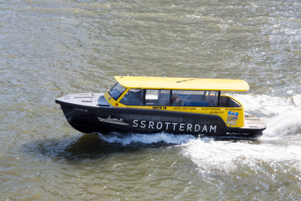 Water taxi speeding over the Maas river in Rotterdam. With 50 departure locations it offers a faster option for transportation within and outside Rotterdam Rotterdam, The Netherlands - April 2019. Water taxi speeding over the Maas river in Rotterdam. With 50 departure locations it offers a faster option for transportation within and outside Rotterdam watertaxi stock pictures, royalty-free photos & images