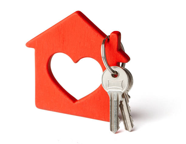 istock Wooden red house and keys isolated on white background. 1151830270