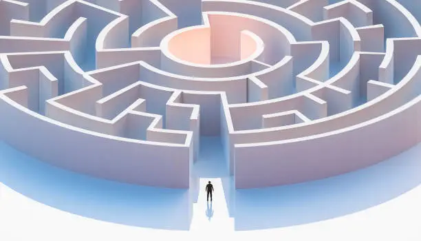 Photo of Man in suit standing in front of a circular or concentric maze entrance. Aerial. Abstract and conceptual 3d render illustration.