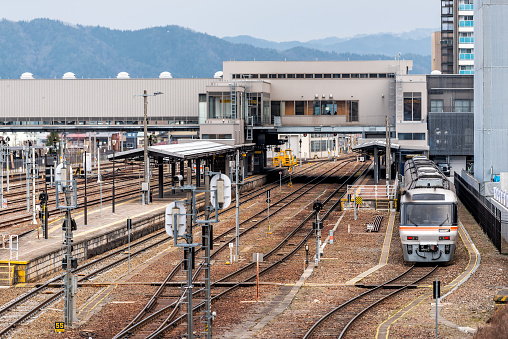 Takayama, Japan - April 6, 2019: JR station tracks with train in Gifu prefecture Hida line high angle view down