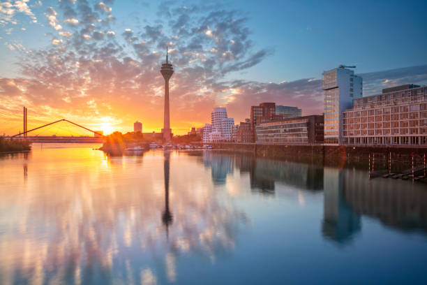 Dusseldorf, Germany. Cityscape image of Düsseldorf, Germany with the Media Harbour and reflection of the city in the Rhine river, during sunrise. media harbor photos stock pictures, royalty-free photos & images