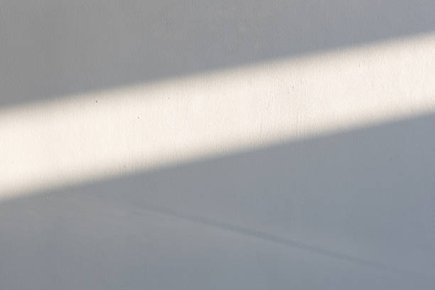 istock simplicity empty white cement wall with line of sun light and shadow at afternoon. used for template, background or texture. 1151831000