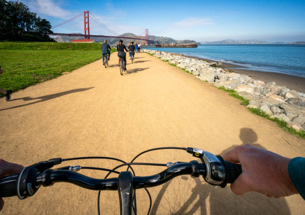 San Francisco, USA - A cyclist's point of view of a journey towards the Golden Gate Bridge, with more cyclists up ahead.