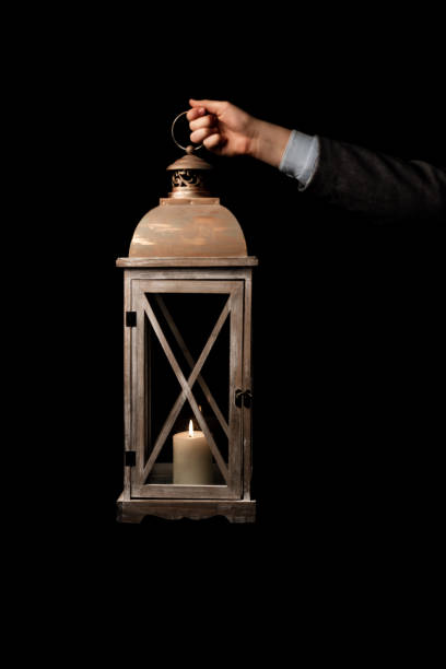 istock Isolated image. Hand holding the old lamp with candle 1151832256