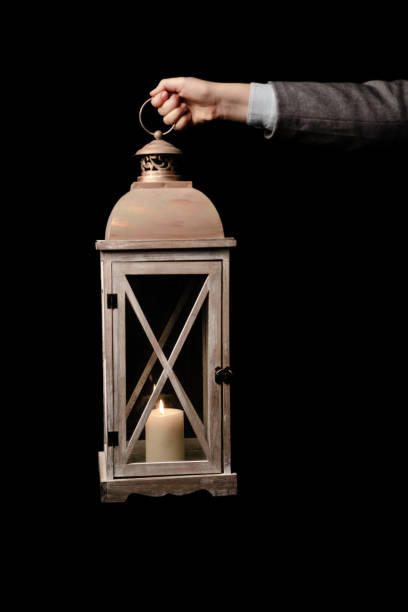 istock Isolated image. Hand holding the old lamp with candle 1151832258