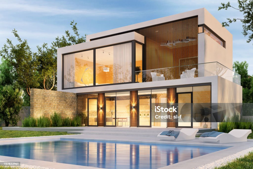 Evening view of a modern large house with swimming pool Evening view of a modern large white house with swimming pool House Stock Photo