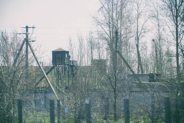 Watchtower at the fence with barbed wire. Soft focus