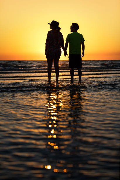 istock Mother and son watching the sunset on a Florida beach 1151837537