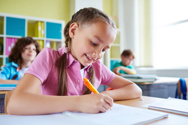 istock Smart little schoolgirl writing in notepad 1151837732