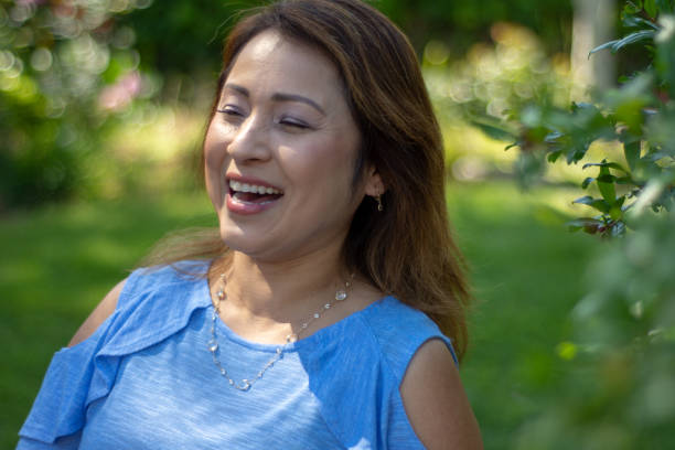 istock Latina Mother Smiling in Back Yard in Spring or Summer 1151838394