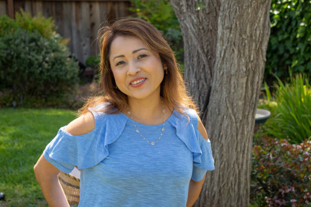istock Latina Mother Smiling in Back Yard in Spring or Summer 1151838436