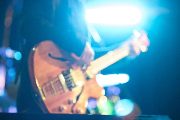 istock Blurred bass guitar player on stage 1151838958