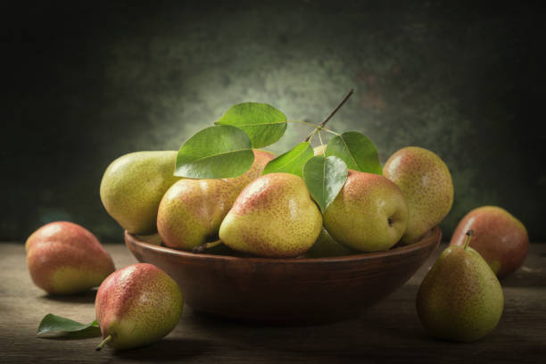 istock still life with fresh pears with leaves in a bowl 1151841025