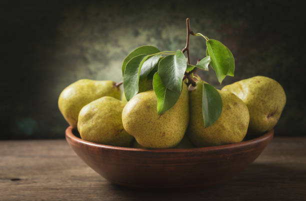 istock still life with fresh pears with leaves in a bowl 1151841029