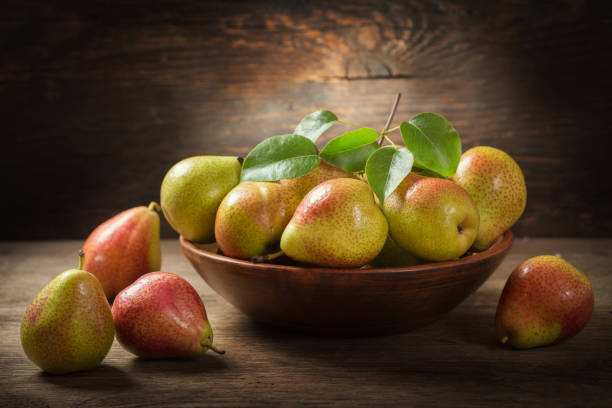 istock still life with fresh pears with leaves in a bowl 1151841047