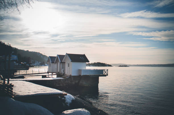 Old Church Perched on Stone in The Middle of Norwegian Fjord at sunset storm.