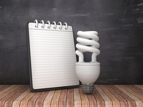Note Pad with Light Bulb on Chalkboard Background - 3D Rendering