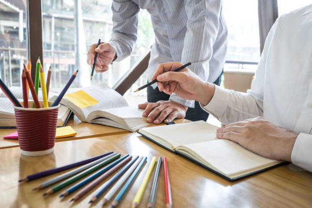 istock Tutor, learning, education, Group of teenager learning studying new lesson to knowledge in library during helping teaching friend education prepare for exam, youth campus friendship teens concept 1151843850