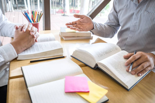 istock Group of young people learning studying new lesson to knowledge in library during helping teaching friend education prepare for exam, youth campus friendship teenager teens concept 1151843875