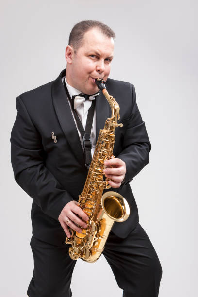 istock Portrait of Expressive Caucasian Player in Suit Playing on Saxophone.Vertical Composition 1151844154
