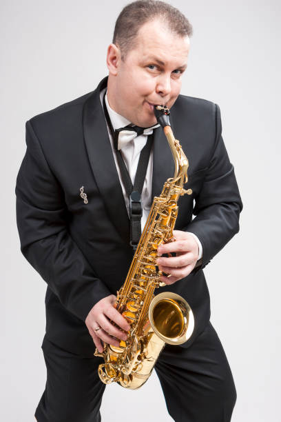 istock Portrait of Expressive Caucasian Player in Suit Playing on Saxophone.Vertical Composition 1151844192