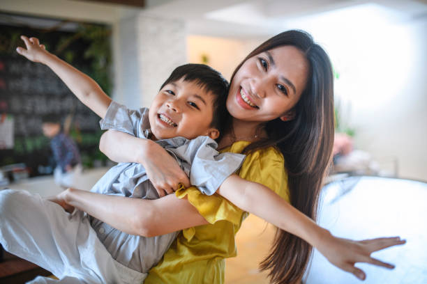 istock Taiwanese Mother and Son Playfully Embracing in Their Home 1151845430
