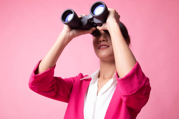 istock Young Asian woman with binoculars. 1151845610