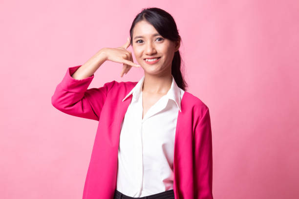 istock Young Asian woman show with phone gesture. 1151846620