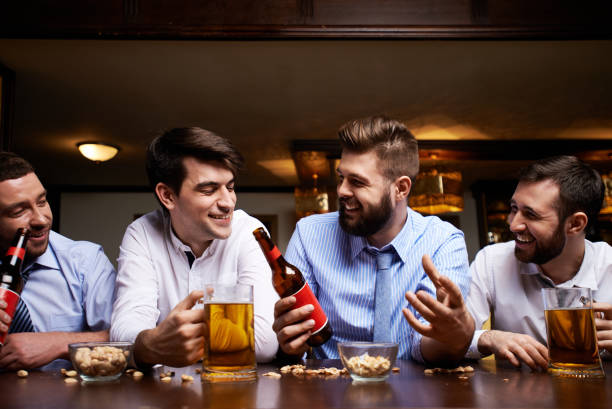 istock Relaxed coworkers having beer in pub 1151846988