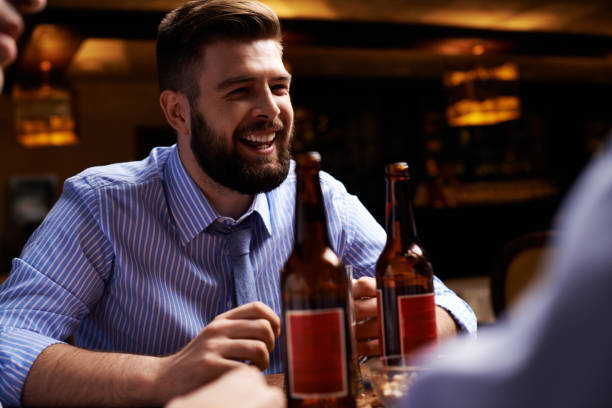 istock Cheerful man having beer with friends 1151847019