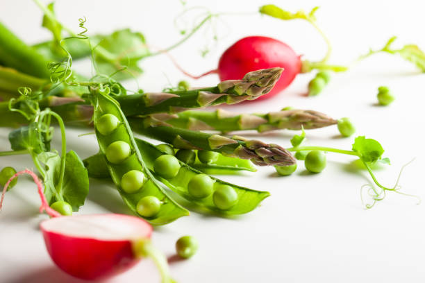 Fresh green  peas pods  with  sprouts, radish and green asparagus