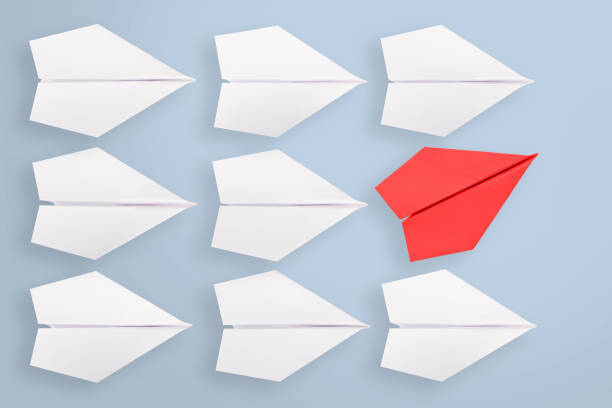 istock Change concepts with red paper airplane leading among white 1151850429