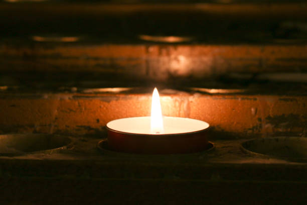 The close up view of lighted tealight candle.