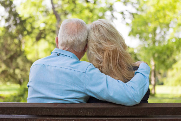 istock Senior couple relaxing outdoors on a park bench 1151851534