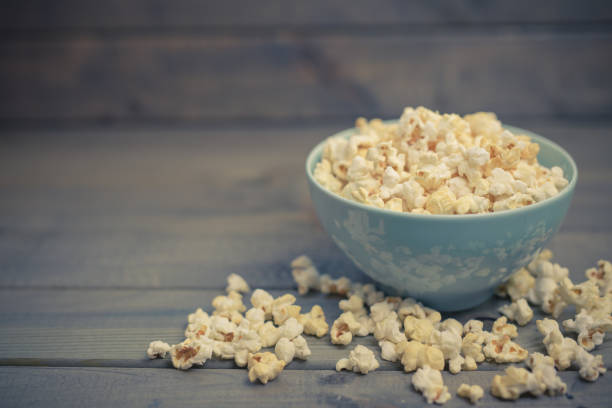 istock Popcorn in a bowl on a wooden table 1151851627