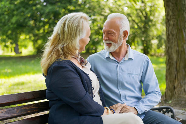 istock Senior couple relaxing outdoors in park 1151851684