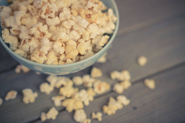 istock Popcorn in a bowl on a wooden table 1151851840