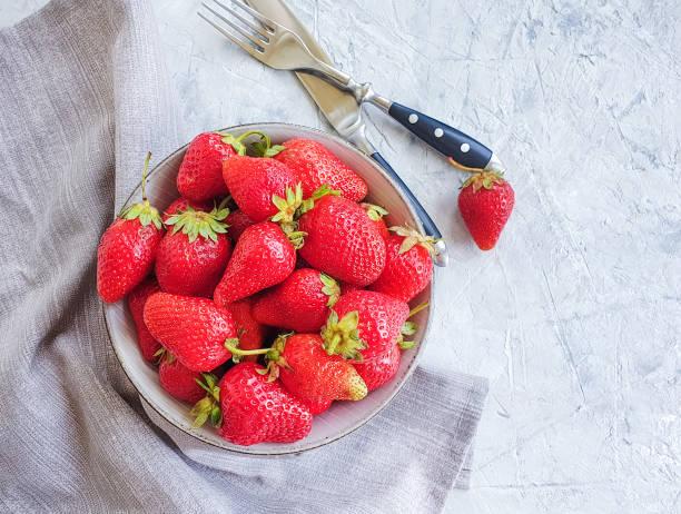 istock fresh strawberries in a plate on gray concrete background 1151852137