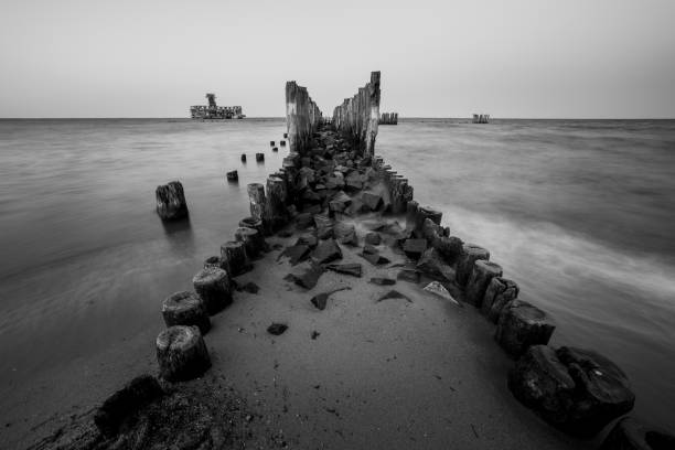 istock Wooden breakwaters on the sea shore 1151853345
